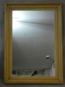 A rectangular wall mirror in moulded pine frame. H.131 W.95cm