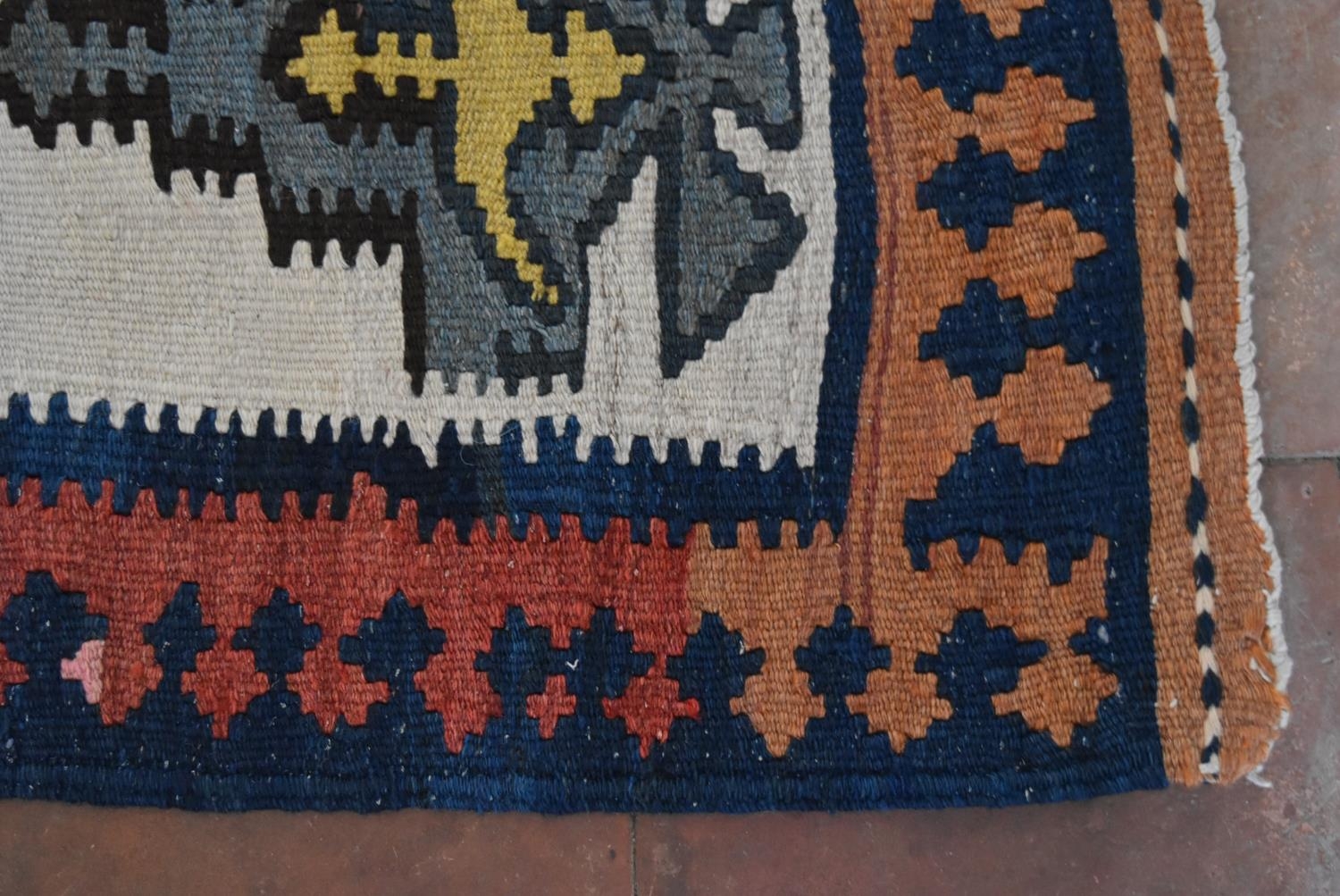 A Persian Kilim with repeating lozenge medallion on umber ground contained by plain spandrels and - Image 3 of 4