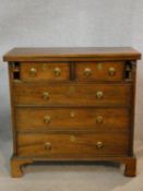 A Georgian bachelor's chest with fold over top above two short and three long drawers on bracket