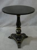 A Victorian style black lacquered lamp table with painted floral decoration on trefoil platform
