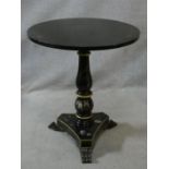 A Victorian style black lacquered lamp table with painted floral decoration on trefoil platform