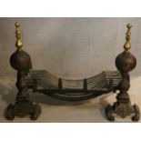 A 19th century cast iron fire grate and fire dogs with brass finials on scroll feet. H.52 W.75 D.