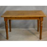 A Victorian style pine kitchen dining table on turned tapering legs. H.74 L.120 W.80cm