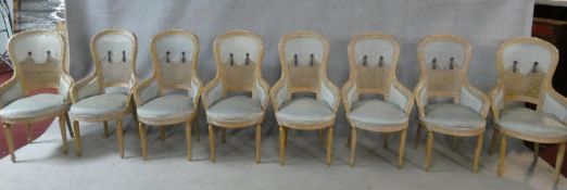 A set of eight Louis XVI style carved beech framed bergere style tub dining chairs in powder blue