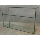 A modernist design plate glass open display side cabinet. H.77 W.118 D.35cm