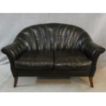 A vintage Tetrad scallop shaped two seater sofa in tobacco leather upholstery on swept supports. H.