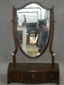 A 19th century mahogany swing dressing mirror on serpentine base fitted with three drawers. H.58 L.