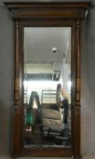 A 19th century French walnut pier mirror of architectural form with original bevelled plate