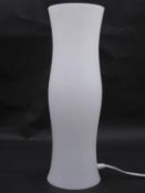 A contemporary opaque glass table lamp of shaped and waisted outline. H.44 W.14cm