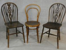 A pair of Windsor wheelback dining chairs and a vintage bentwood cafe chair. H.93cm
