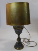 An antique Royal Doulton pottery and brass converted oil lamp, having a trefoil gallery above a