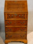 A Georgian style yew and crossbanded fitted bureau. H.100 W.51 D.47cm