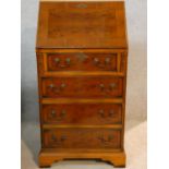 A Georgian style yew and crossbanded fitted bureau. H.100 W.51 D.47cm