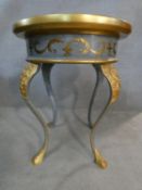 A painted lamp table with arabesque detail to the top and classical motifs to the frieze raised on