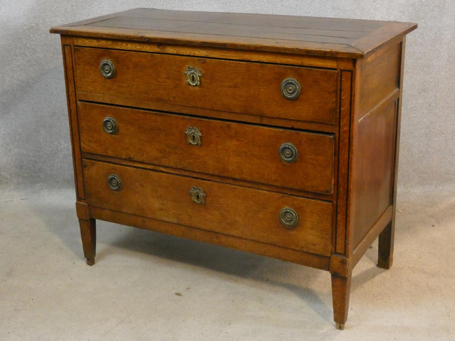 A 19th century French Provincial oak commode chest of three long drawers on square tapering - Image 2 of 8