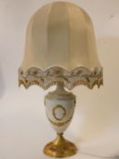 An Empire style gilt glazed ceramic table lamp with central cartouche and husk swag decoration. H.