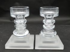 A pair of glass candlesticks with frosted glass square pedestal bases. H.21 L.15 W.15cm