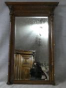 A 19th century Continental carved oak pier mirror with original plate flanked by turned pilasters on