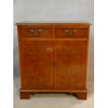 A Georgian style yew and crossbanded side cabinet. H.80 W.72 D.41cm