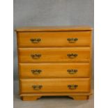 A 19th century style pine chest of four long drawers. H.84 W.86 D.44cm
