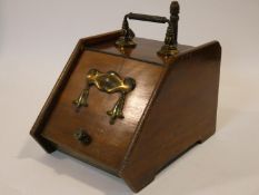 A 19th century walnut coal box with Art Nouveau style embossed brass decoration and with original