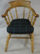 A late 19th century elm captain's armchair with plaid squab cushion. H.85cm