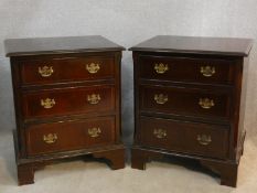A pair of Georgian style mahogany and crossbanded three drawer bedside cabinets. H.71 W.60 D.50cm
