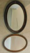 A C.1900 bevelled glass wall mirror in moulded frame and a similar mirror. H.87 W.61cm (largest)