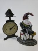 A Mr Punch cast iron doorstop along with vintage kitchen scales and a set of weights. H.30cm