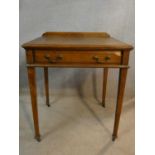 A C.1900 oak Howard and Sons writing table with single drawer raised on square tapering supports