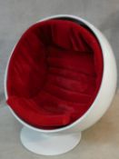 After Eero Aarnio, a vintage white polyester Ball Chair on swivel metal base with red velour