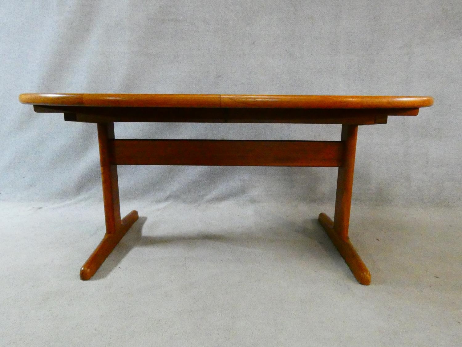 A 1960's vintage teak extending dining table on trestle style supports with extra leaf. H.72 L.167 - Image 3 of 9