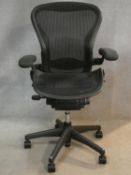 A contemporary Herman Miller ergonomic design tilting and swivelling Aeron office desk chair, size