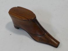 An antique wooden treen snuff box in the form of a heeled boot. Brass stud detailing to the boot