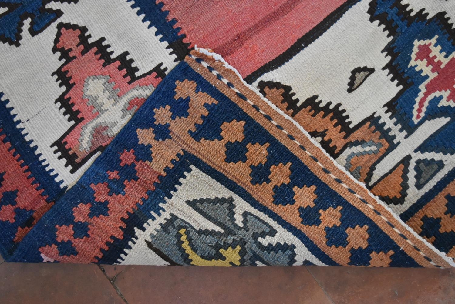 A Persian Kilim with repeating lozenge medallion on umber ground contained by plain spandrels and - Image 4 of 4