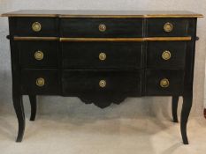 An ebonised and gilt Louis XV style three drawer commode of shaped outline on cabriole supports. H.