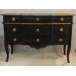 An ebonised and gilt Louis XV style three drawer commode of shaped outline on cabriole supports. H.