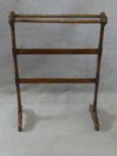 A 19th century mahogany towel rail on turned supports resting on platform feet. H.91 L.66 W.30cm