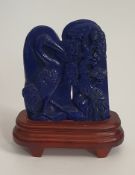 A large Chinese Lapis Lazuli carving with a crane and a bonsai tree mounted on a wooden stand. H.