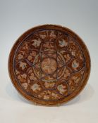 A Persian glazed ceramic lustre plate decorated with birds, fish and flowers. H.30cm