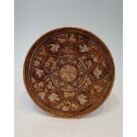 A Persian glazed ceramic lustre plate decorated with birds, fish and flowers. H.30cm