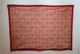 Hanging at Bismillah North Africa. Cotton textile with reserve decoration on a red background of the