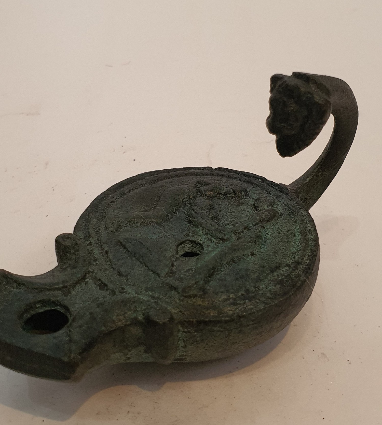 A Roman style bronze oil lamp with animal head finial to the handle and impressed design. H.9cm - Image 3 of 3