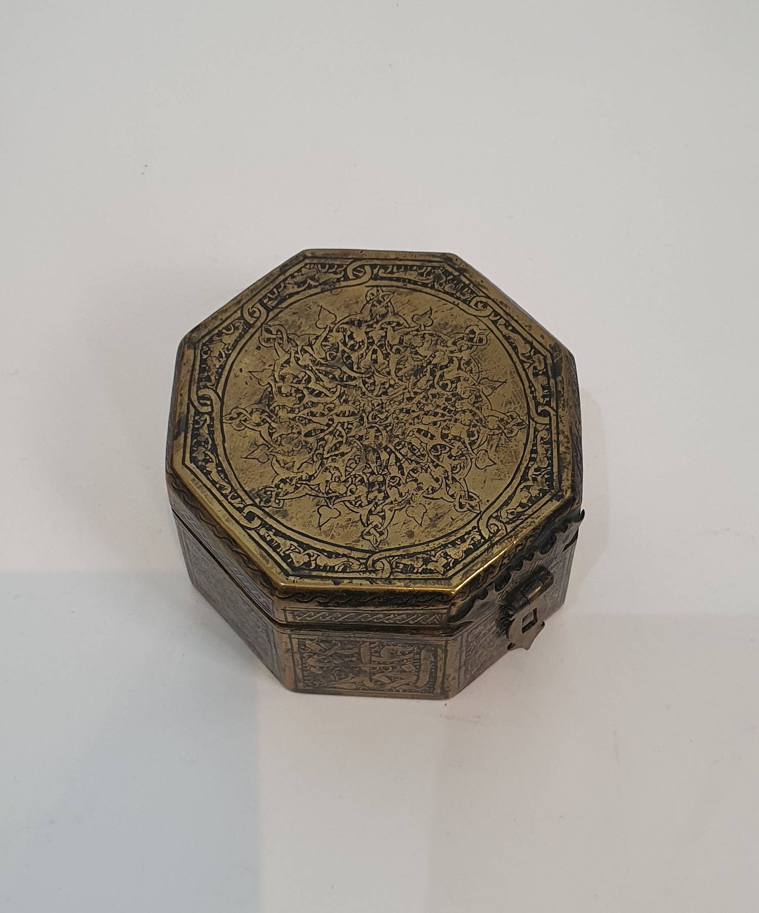 An Islamic hinged brass box with clasp engraved with a stylised calligraphy design along with two - Image 2 of 6
