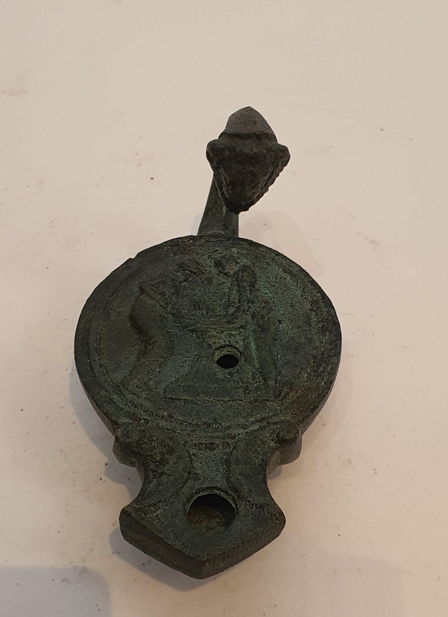 A Roman style bronze oil lamp with animal head finial to the handle and impressed design. H.9cm - Image 2 of 3