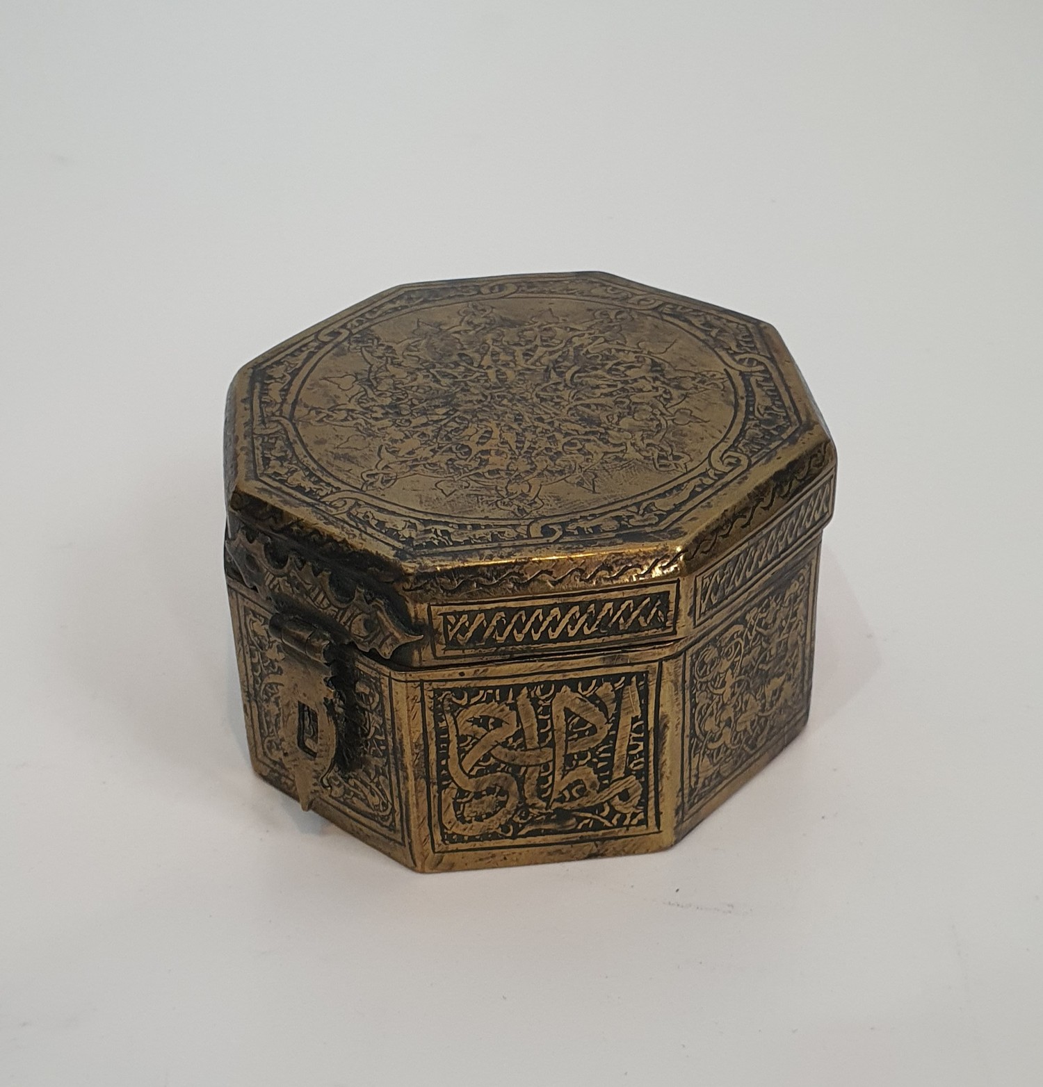 An Islamic hinged brass box with clasp engraved with a stylised calligraphy design along with two - Image 3 of 6