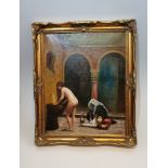 A gilt framed Eastern oil on canvas of a nude female washing clothes in a fountain. Unsigned. H.