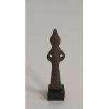 An Oriental early bronze figure of a deity on stand. H.10cm