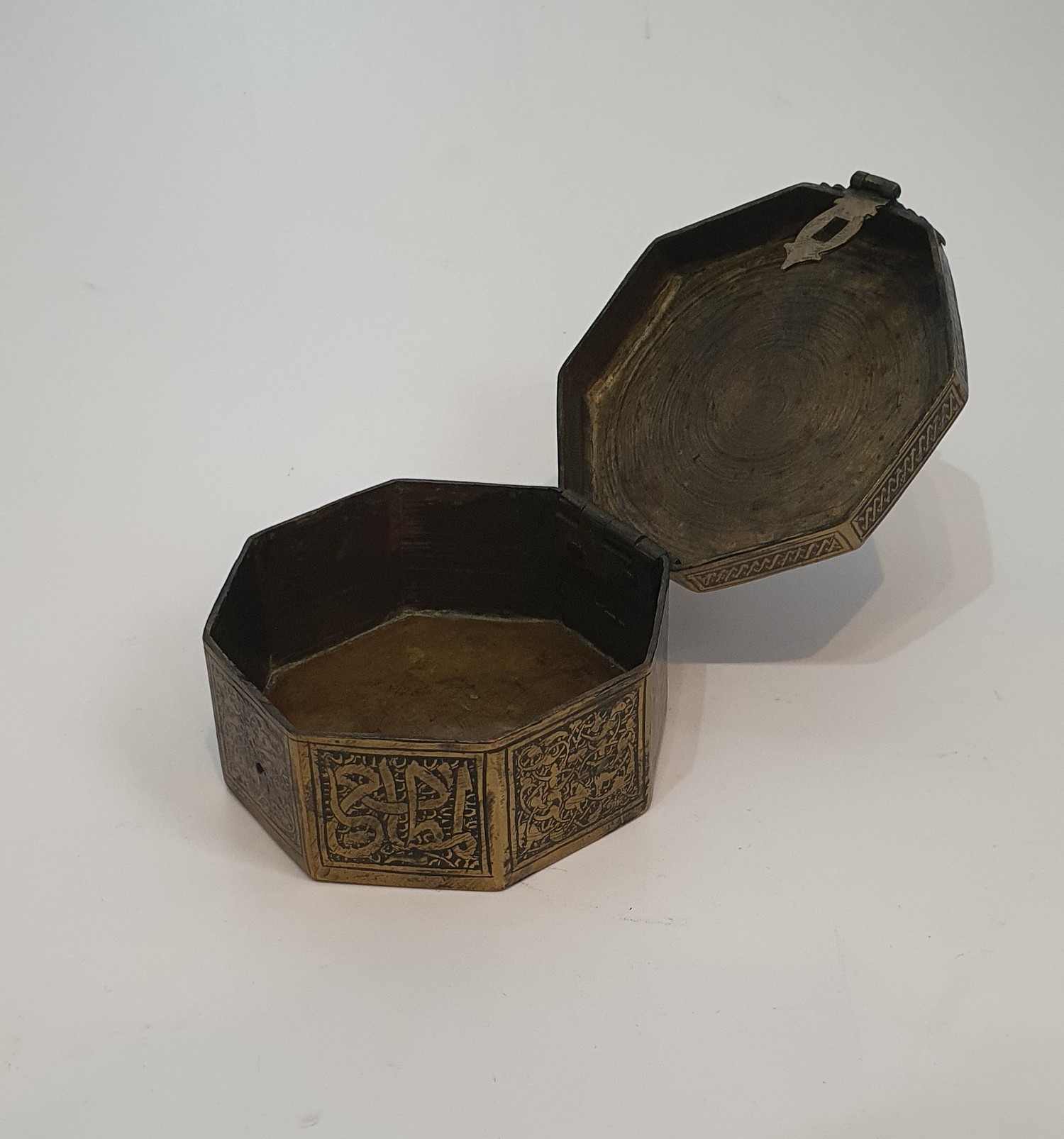 An Islamic hinged brass box with clasp engraved with a stylised calligraphy design along with two - Image 4 of 6