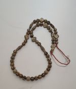 A Chinese Pumtek bead necklace, made from fossilized palm wood with a Batik design. L59cm/118cm.